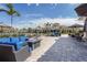 Stylish outdoor patio with comfortable lounge seating, dining tables, and lush tropical landscaping at 5517 Palmer Cir # 203, Bradenton, FL 34211