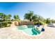 A uniquely-shaped outdoor pool with a lift and rock features, set against a backdrop of palm trees at 5517 Palmer Cir # 203, Bradenton, FL 34211