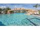 Beautiful in-ground pool with a stone archway and waterfall feature for luxurious swimming at 5517 Palmer Cir # 203, Bradenton, FL 34211