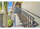Staircase with black railings leading to the screened-in porch of this lovely, beige condo at 5517 Palmer Cir # 203, Bradenton, FL 34211