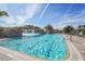 A stunning pool featuring a rock waterfall, framed by lush greenery, with ample lounge chairs at 5517 Palmer Cir # 203, Bradenton, FL 34211