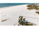 Stunning aerial view of the expansive white sand beach with volleyball nets at 5740 Midnight Pass Rd # 402, Sarasota, FL 34242