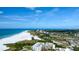 Aerial shot of the condominium providing panoramic ocean views, pristine beach access, and a beautiful coastal lifestyle at 5740 Midnight Pass Rd # 402, Sarasota, FL 34242