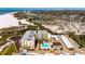 Aerial view of a beachfront condo complex, showcasing its proximity to the ocean and well-maintained grounds at 5740 Midnight Pass Rd # 402, Sarasota, FL 34242