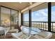 Ocean view balcony with table, chairs and a lounge chair that overlooks the beautiful beach at 5740 Midnight Pass Rd # 402, Sarasota, FL 34242