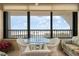 Outdoor ocean view balcony furnished with table and chairs for relaxing and enjoying the ocean view at 5740 Midnight Pass Rd # 402, Sarasota, FL 34242