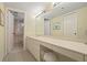 Bathroom featuring ample countertop space, neutral tiling, and a separate toilet and shower area at 5740 Midnight Pass Rd # 402, Sarasota, FL 34242