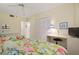 Comfortable bedroom with two beds, a work desk, ceiling fan, and closet for plenty of storage at 5740 Midnight Pass Rd # 402, Sarasota, FL 34242