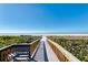 Scenic boardwalk leading to a pristine beach with white sand and clear blue ocean at 5740 Midnight Pass Rd # 402, Sarasota, FL 34242
