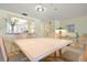 Bright dining room with seating for six and a view of the kitchen at 5740 Midnight Pass Rd # 402, Sarasota, FL 34242