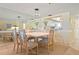 Dining room featuring a dining table with seating for six and mirrored wall that reflects into the kitchen at 5740 Midnight Pass Rd # 402, Sarasota, FL 34242