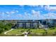 The condo building boasts meticulous grounds, adorned with palm trees and manicured lawns, enhancing its curb appeal at 5740 Midnight Pass Rd # 402, Sarasota, FL 34242