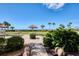 Scenic outdoor space with palm trees, picnic tables, and a path leading to the beach at 5740 Midnight Pass Rd # 402, Sarasota, FL 34242