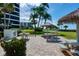 Grilling area on the building grounds with picnic tables and shade structures nearby at 5740 Midnight Pass Rd # 402, Sarasota, FL 34242