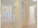 Bright hallway with tile floors and multiple storage closets leading to bathroom and entryway at 5740 Midnight Pass Rd # 402, Sarasota, FL 34242