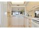 Bright kitchen with views into dining room and updated appliances at 5740 Midnight Pass Rd # 402, Sarasota, FL 34242