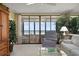 Living room with water views from balcony, comfortable seating, and natural light at 5740 Midnight Pass Rd # 402, Sarasota, FL 34242
