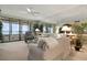 Spacious living room with comfortable furniture and access to an outdoor balcony at 5740 Midnight Pass Rd # 402, Sarasota, FL 34242