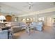 Spacious living room with mirrored walls, two sofas, sitting chair and open to dining area at 5740 Midnight Pass Rd # 402, Sarasota, FL 34242