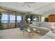 Inviting living room with a neutral color palette and floor to ceiling windows at 5740 Midnight Pass Rd # 402, Sarasota, FL 34242
