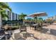 Relaxing outdoor seating area with a view of the tranquil water and lush tropical landscaping at 5740 Midnight Pass Rd # 402, Sarasota, FL 34242
