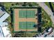 Aerial view of well-maintained tennis courts surrounded by lush landscaping, providing an inviting recreational space at 5740 Midnight Pass Rd # 402, Sarasota, FL 34242