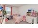 Cozy bedroom featuring plush bedding, ample natural light, and neutral carpet at 5778 Windy Bay Ter, Nokomis, FL 34275