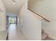 Inviting hallway with tile flooring, leading to dining area and showcasing natural light at 5778 Windy Bay Ter, Nokomis, FL 34275