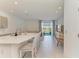Open-concept kitchen with island seating, recessed lighting, and access to outdoor views at 5778 Windy Bay Ter, Nokomis, FL 34275