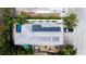 Aerial view of a home featuring solar panels, a swimming pool, and a well-maintained yard at 5802 De Palmas Ave, Holmes Beach, FL 34217