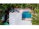 Aerial view showcases pool, patio, and lush landscaping, revealing a private outdoor oasis for relaxation and entertainment at 5802 De Palmas Ave, Holmes Beach, FL 34217