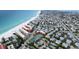 Aerial view of a coastal home near the beach featuring solar panels and lush tropical landscaping at 5802 De Palmas Ave, Holmes Beach, FL 34217