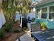 Tropical backyard oasis with lush foliage, a grill, and comfortable seating, perfect for relaxing and entertaining at 5802 De Palmas Ave, Holmes Beach, FL 34217