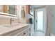 Well-lit bathroom featuring a modern vanity, stylish fixtures, and a convenient door to an outside area at 5802 De Palmas Ave, Holmes Beach, FL 34217
