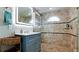 Updated bathroom with tiled shower, sleek vanity, and modern lighting at 5802 De Palmas Ave, Holmes Beach, FL 34217