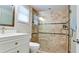 Updated bathroom features a walk-in shower with decorative tile and a modern vanity with ample storage at 5802 De Palmas Ave, Holmes Beach, FL 34217