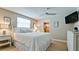 This bright bedroom features a ceiling fan, light decor, and wood floors at 5802 De Palmas Ave, Holmes Beach, FL 34217