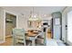 Light-filled dining area with wood table, pendant lighting, and easy access to the kitchen at 5802 De Palmas Ave, Holmes Beach, FL 34217