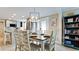 Open dining room with table set for six, tile floors, and adjacent updated kitchen at 5802 De Palmas Ave, Holmes Beach, FL 34217