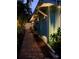 Night view of home exterior with well-maintained landscaping, elegant lighting, and a welcoming pathway at 5802 De Palmas Ave, Holmes Beach, FL 34217