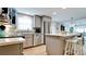 Modern kitchen with stainless steel appliances, granite countertops, and an open layout to the dining area at 5802 De Palmas Ave, Holmes Beach, FL 34217