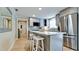 Contemporary kitchen featuring stainless steel appliances, a center island with seating, and stylish gray cabinetry at 5802 De Palmas Ave, Holmes Beach, FL 34217