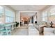 Bright sunroom features tile floors, comfortable seating, and views into the open concept kitchen and living spaces at 5802 De Palmas Ave, Holmes Beach, FL 34217