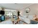 Cozy living room with neutral decor, round mirror, and an open layout at 5802 De Palmas Ave, Holmes Beach, FL 34217
