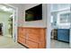 This main bedroom features walk-in closets, a vanity, and a wall-mounted television at 5802 De Palmas Ave, Holmes Beach, FL 34217