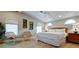 This bedroom features a ceiling fan, two lounge chairs, and a king bed at 5802 De Palmas Ave, Holmes Beach, FL 34217