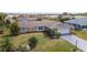 Aerial view of a well-kept home with a green lawn, mature landscaping, and a long driveway at 5859 Lincoln Rd, Venice, FL 34293