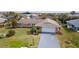 Aerial view of a well-kept home with a green lawn, mature landscaping, and a long driveway at 5859 Lincoln Rd, Venice, FL 34293