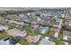 Sprawling aerial view of a residential neighborhood featuring neatly arranged homes and tree-lined streets at 5859 Lincoln Rd, Venice, FL 34293