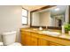 Bathroom featuring a vanity with granite countertop, mirror, sink, and toilet at 5859 Lincoln Rd, Venice, FL 34293